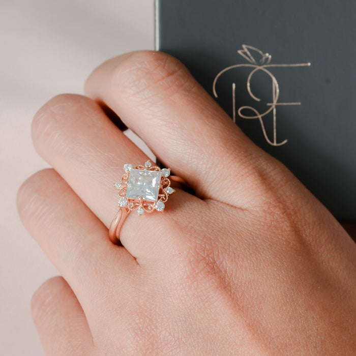 princess cut moissanite filigree ring on finger